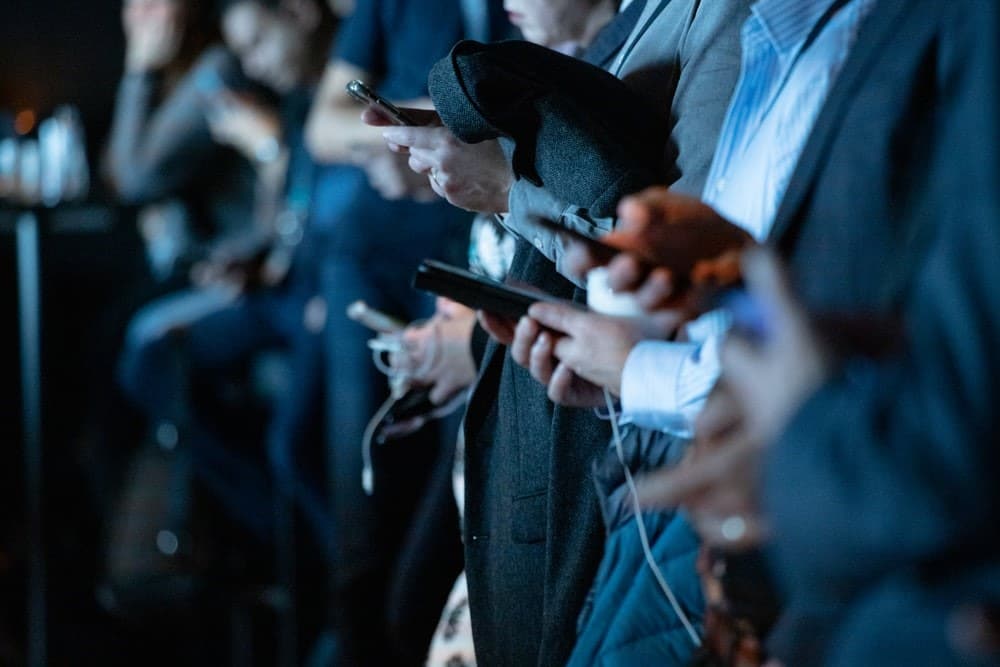 people engaged in social media on their phones. 