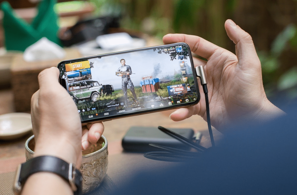 A person is playing video games on a smartphone